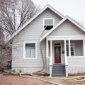 A residential home with insulation tubing run through an upstairs window.