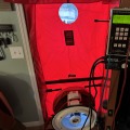 Red blower door system with black cent fan and electronic monitor.