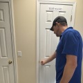 A worker closing the white interior door.